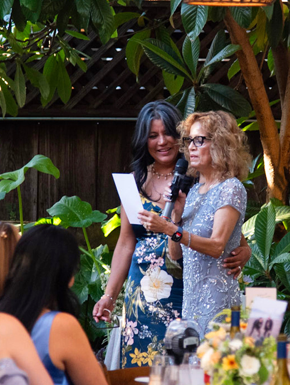 Two women standing and giving a speech