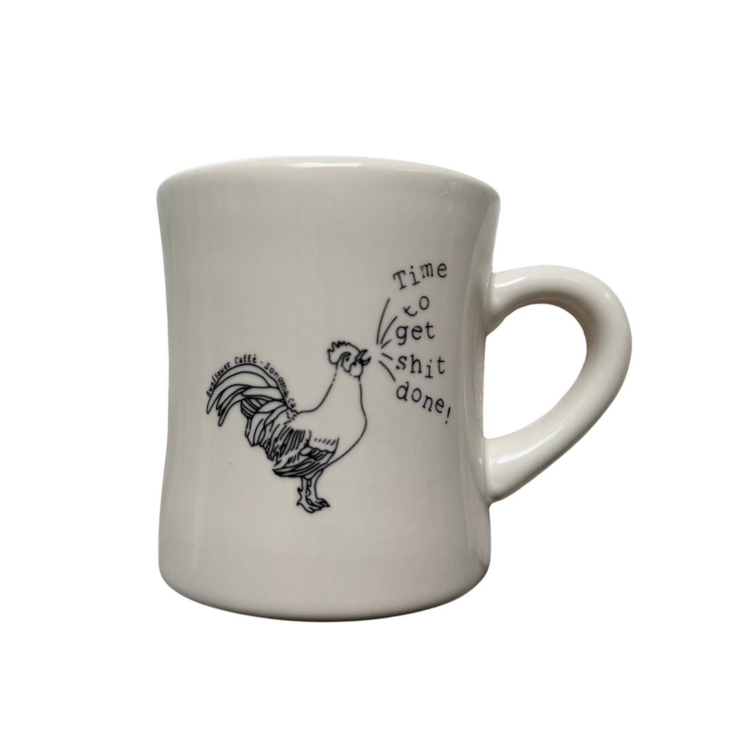 A white ceramic coffee mug with a black line art illustration of a rooster and the handwritten text 'time to get shit done!' set against a plain white background. 