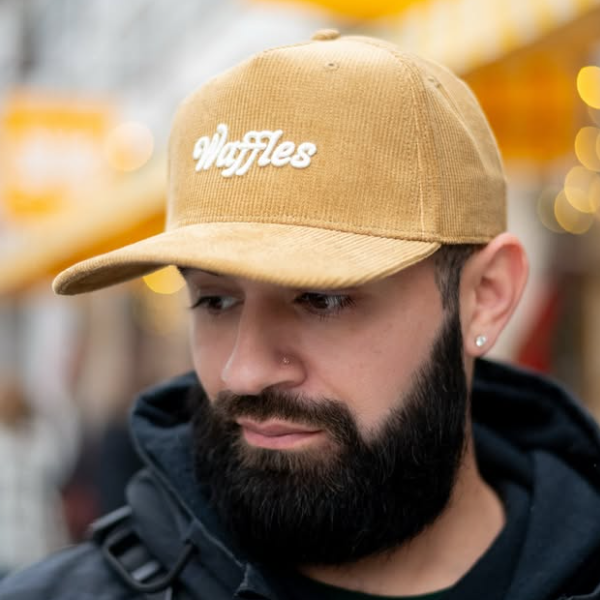 A soft corduroy cap embroidered with Waffles — golden, nostalgic, and always a good idea.

Golden mornings deserve a golden hat.

This corduroy cap features Waffles embroidered on the front with Sunflower Caffé stitched on the back — a playful nod to one of our most-loved brunch classics. Designed for easy mornings, cozy layers, and those who know breakfast is best enjoyed slow.

Finished with an adjustable snapback for everyday comfort.

Soft corduroy fabric
Embroidered Waffles front detail
“Sunflower Caff