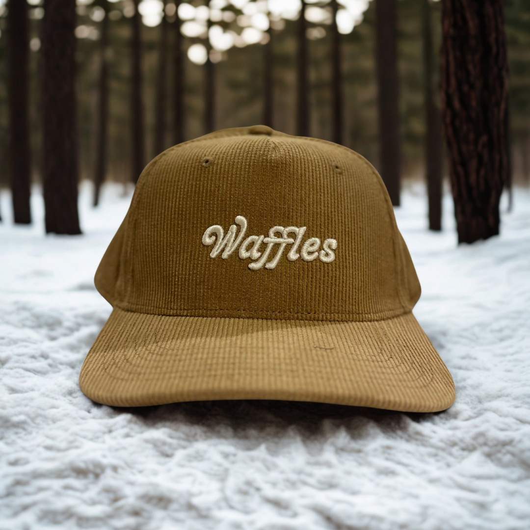 A soft corduroy cap embroidered with Waffles — golden, nostalgic, and always a good idea.

Golden mornings deserve a golden hat.

This corduroy cap features Waffles embroidered on the front with Sunflower Caffé stitched on the back — a playful nod to one of our most-loved brunch classics. Designed for easy mornings, cozy layers, and those who know breakfast is best enjoyed slow.

Finished with an adjustable snapback for everyday comfort.

Soft corduroy fabric
Embroidered Waffles front detail
“Sunflower Caff